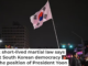 A man holds the South Korean flag outside the National Assembly in Seoul on Dec. 4, 2024, after President Yoon Suk Yeol declared emergency martial law. Anthony Wallace/AFP/Getty Images